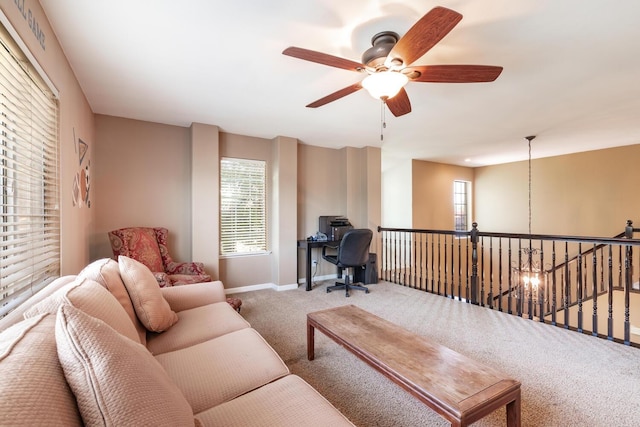 carpeted living room with baseboards, plenty of natural light, and a ceiling fan