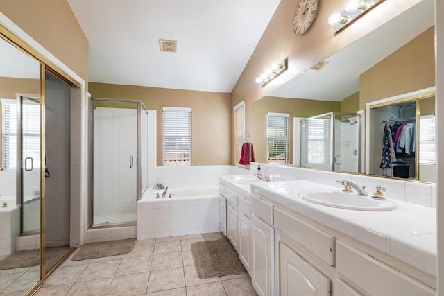 bathroom with a sink, vaulted ceiling, a stall shower, and a garden tub