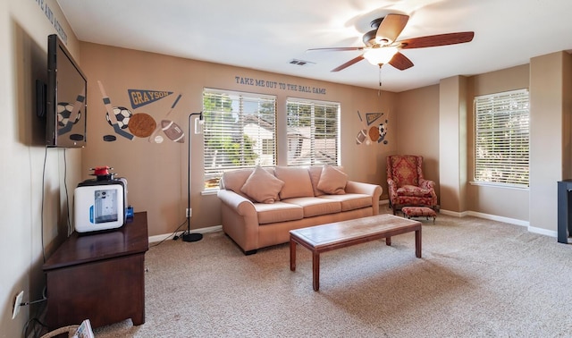 carpeted living area featuring baseboards, a ceiling fan, and visible vents