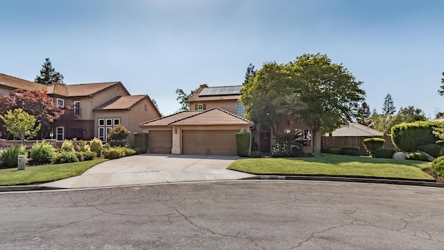 traditional home featuring a front yard, roof mounted solar panels, concrete driveway, an attached garage, and stucco siding