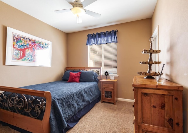 bedroom with baseboards, ceiling fan, and light colored carpet