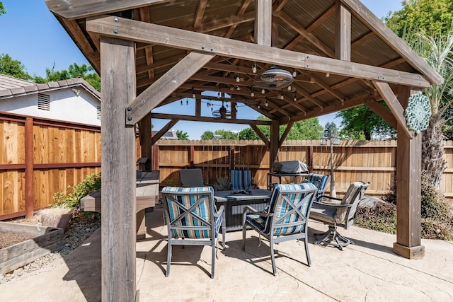 view of patio featuring a gazebo and a fenced backyard