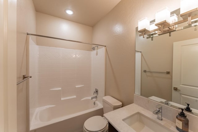 bathroom featuring a textured wall, vanity, toilet, recessed lighting, and  shower combination