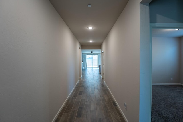 hallway with baseboards, recessed lighting, and wood finished floors
