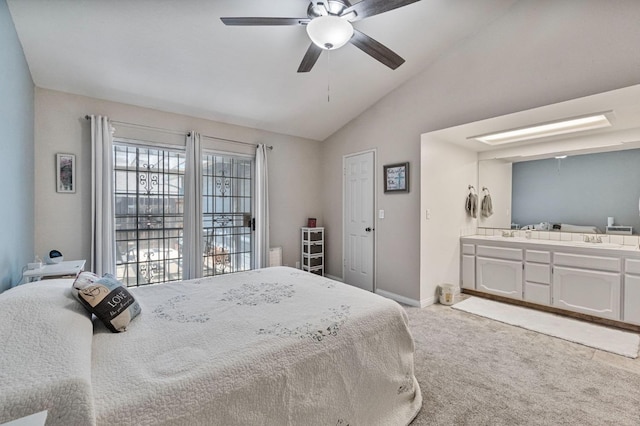 bedroom with a ceiling fan, vaulted ceiling, a sink, baseboards, and light carpet
