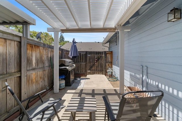 view of patio / terrace with a gate, fence, and area for grilling