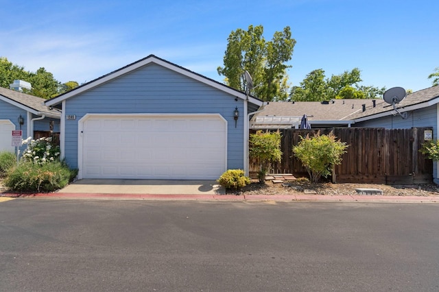 single story home with fence and a garage
