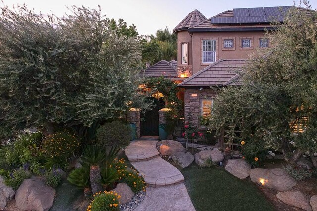 71 Omaha Ave, Clovis, CA 93619 - rear view of property featuring roof mounted solar panels and stone siding
