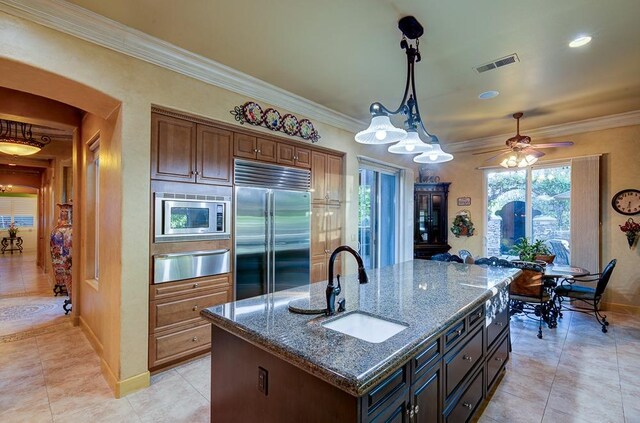 71 Omaha Ave, Clovis, CA 93619 - kitchen with built in appliances, a sink, a warming drawer, baseboards, and light tile patterned floors