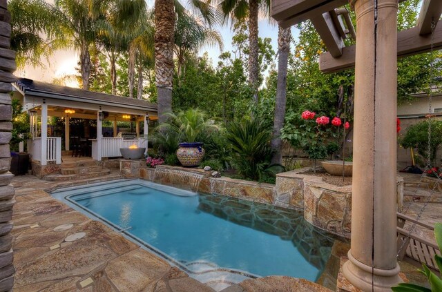 71 Omaha Ave, Clovis, CA 93619 - pool at dusk featuring an outdoor pool and a patio