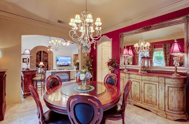 71 Omaha Ave, Clovis, CA 93619 - dining area with a chandelier, arched walkways, ornamental molding, and light tile patterned floors