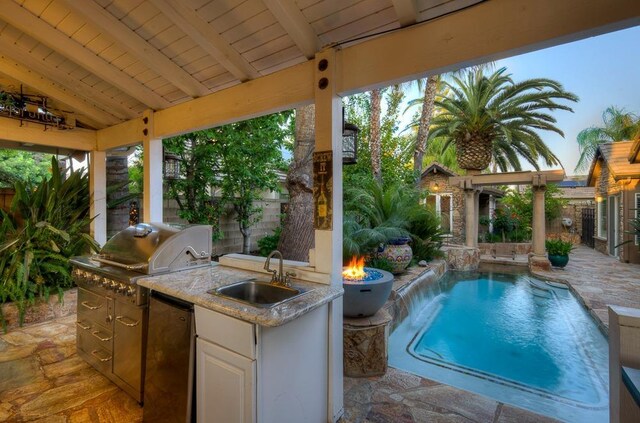 71 Omaha Ave, Clovis, CA 93619 - fenced backyard with a sink, a patio, and an outdoor fire pit