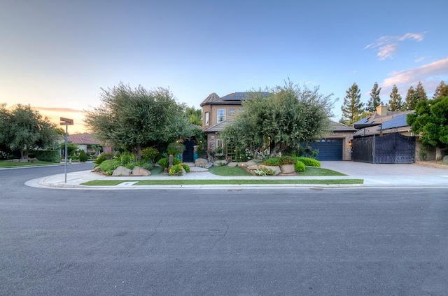 71 Omaha Ave, Clovis, CA 93619 - view of property hidden behind natural elements featuring driveway, solar panels, and a garage