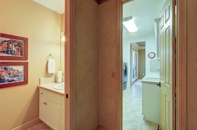 bathroom featuring washer / dryer and vanity
