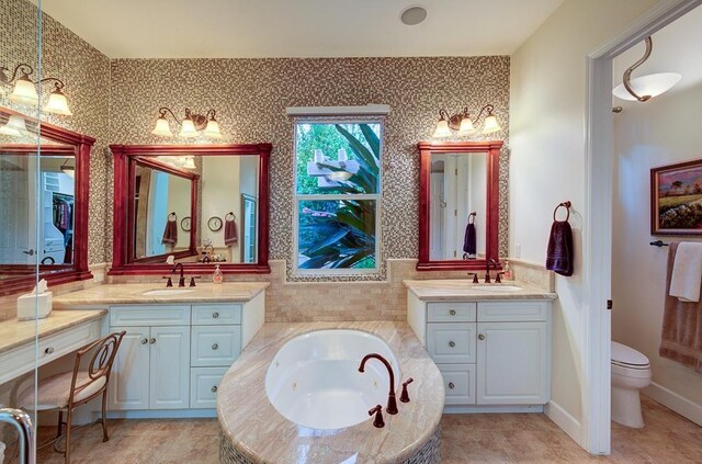 71 Omaha Ave, Clovis, CA 93619 - full bath with two vanities, a tub with jets, toilet, and tile patterned floors