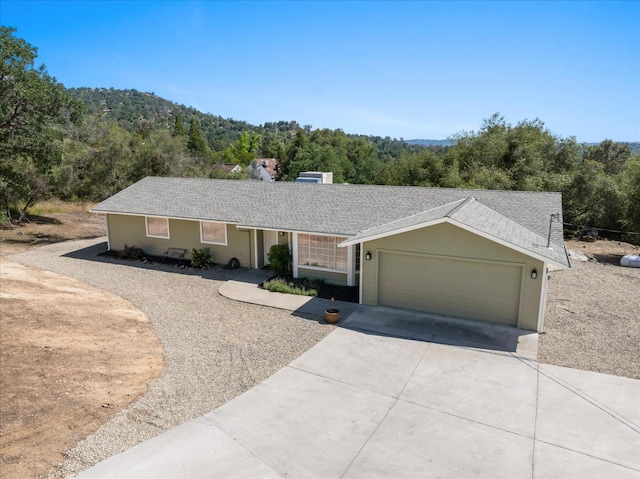 42968 Ranger Circle Dr, Coarsegold, CA 93614 - ranch-style house with an attached garage, a forest view, and concrete driveway