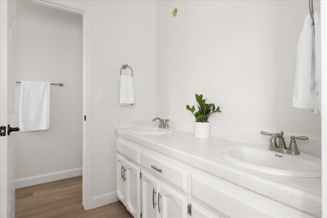 42968 Ranger Circle Dr, Coarsegold, CA 93614 - bathroom featuring a sink, baseboards, double vanity, and wood finished floors