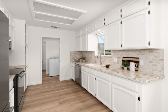 42968 Ranger Circle Dr, Coarsegold, CA 93614 - kitchen with white cabinets, appliances with stainless steel finishes, a sink, washer / clothes dryer, and visible vents