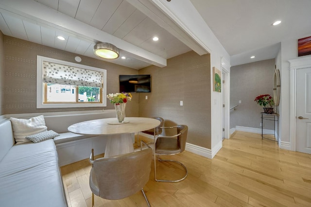dining space featuring light wood-style floors, recessed lighting, baseboards, and beam ceiling