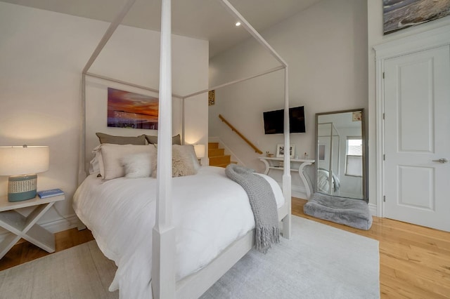 bedroom featuring baseboards, recessed lighting, and wood finished floors