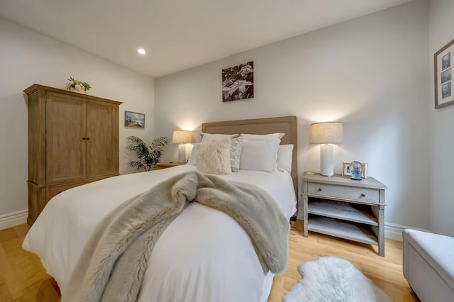 bedroom featuring recessed lighting, light wood finished floors, and baseboards