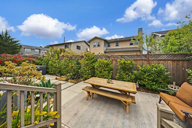 view of patio / terrace featuring a residential view, outdoor dining space, and a fenced backyard