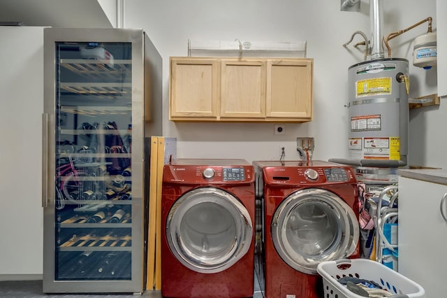 laundry room with beverage cooler, cabinet space, and washing machine and clothes dryer