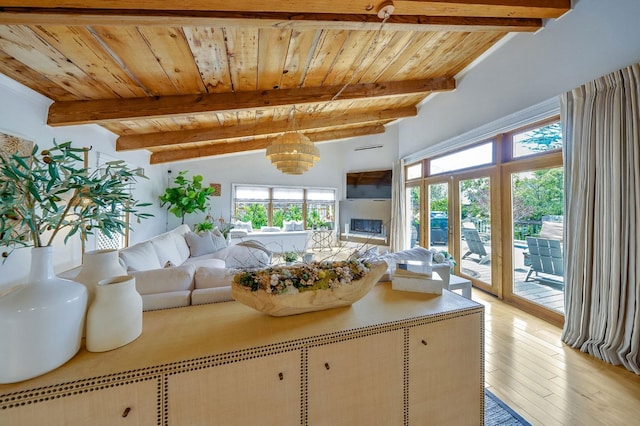 living room with wood ceiling, beamed ceiling, and a healthy amount of sunlight