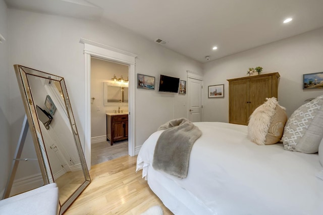 bedroom featuring connected bathroom, recessed lighting, visible vents, and light wood finished floors