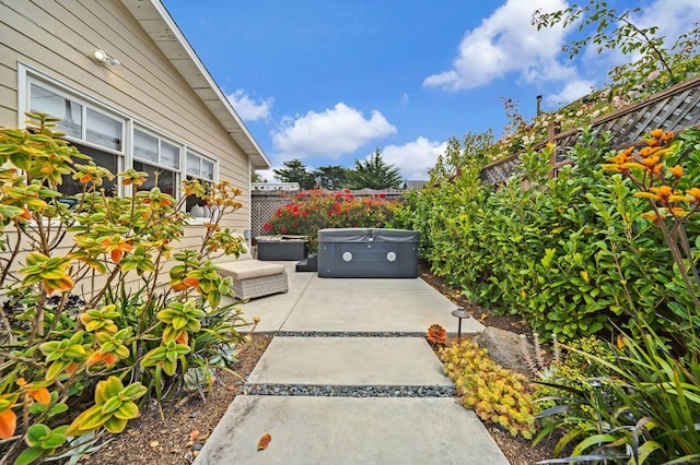 view of patio / terrace with a hot tub