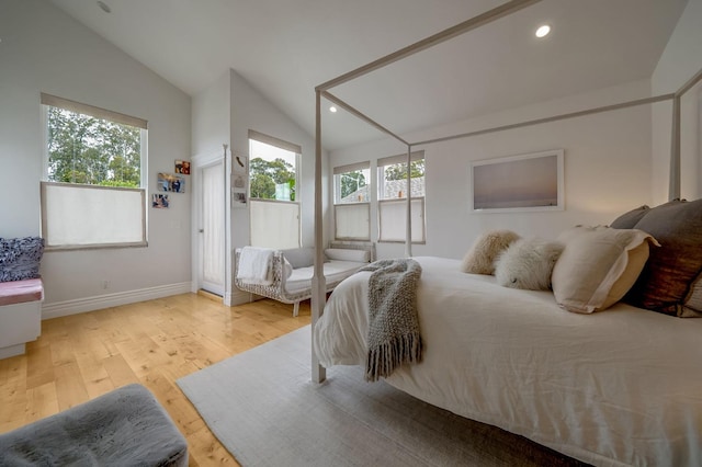 bedroom with recessed lighting, baseboards, vaulted ceiling, and light wood-type flooring