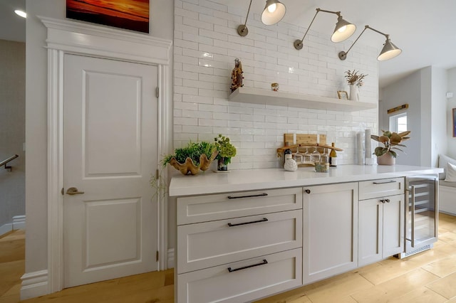 interior space featuring beverage cooler and tasteful backsplash