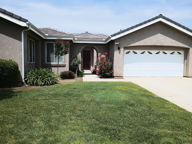 2979 Duncan Ave, Clovis, CA 93611 - ranch-style home with stucco siding, a front yard, driveway, an attached garage, and a tile roof