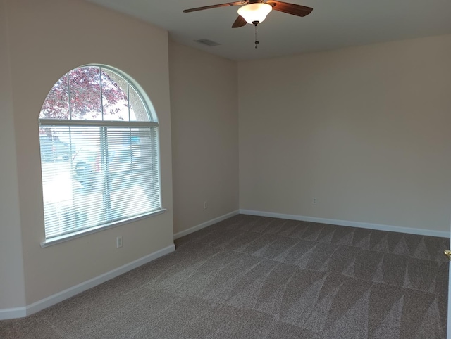 2979 Duncan Ave, Clovis, CA 93611 - spare room featuring a ceiling fan, dark colored carpet, and baseboards