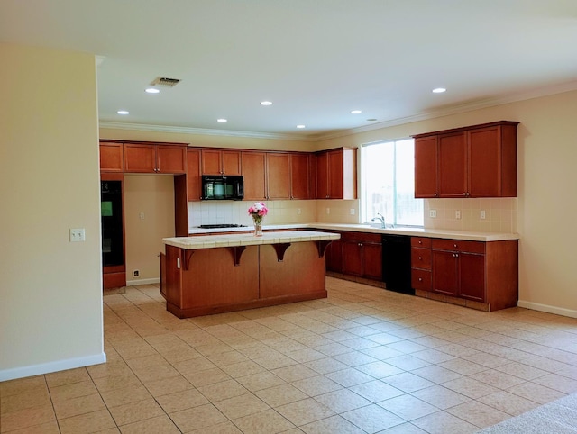 2979 Duncan Ave, Clovis, CA 93611 - kitchen with black appliances, light countertops, backsplash, a breakfast bar, and crown molding