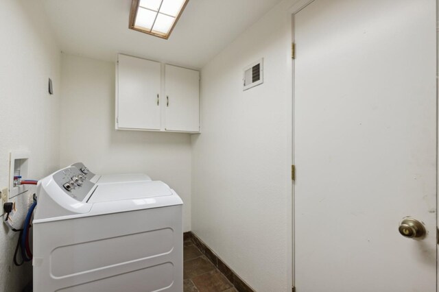 1167 Silver Tip Ln, Fish Camp, CA 93623 - laundry area featuring independent washer and dryer, cabinet space, and dark stone finish floors