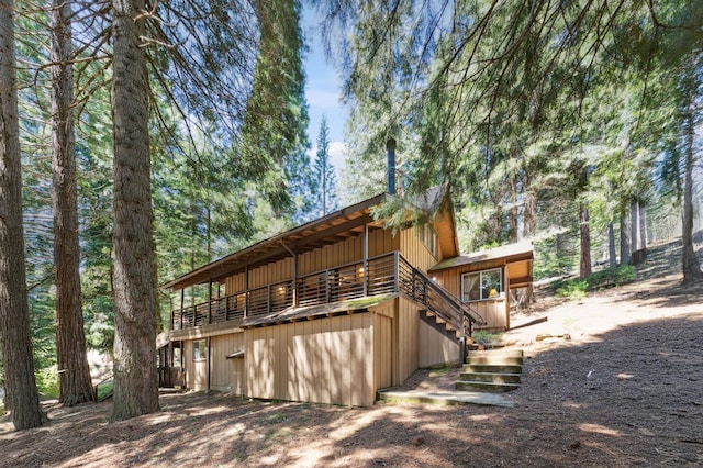 back of property with a wooden deck
