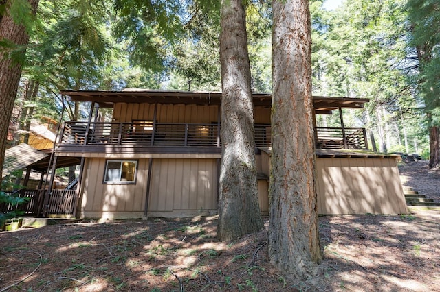 rear view of property featuring board and batten siding