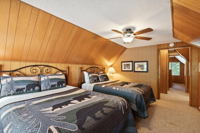 1167 Silver Tip Ln, Fish Camp, CA 93623 - bedroom featuring carpet, lofted ceiling, wood walls, a textured ceiling, and a ceiling fan