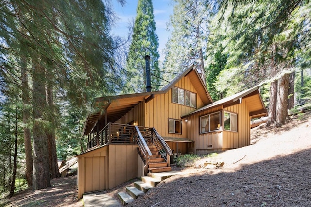 1167 Silver Tip Ln, Fish Camp, CA 93623 - back of house with stairs, a deck, crawl space, and board and batten siding