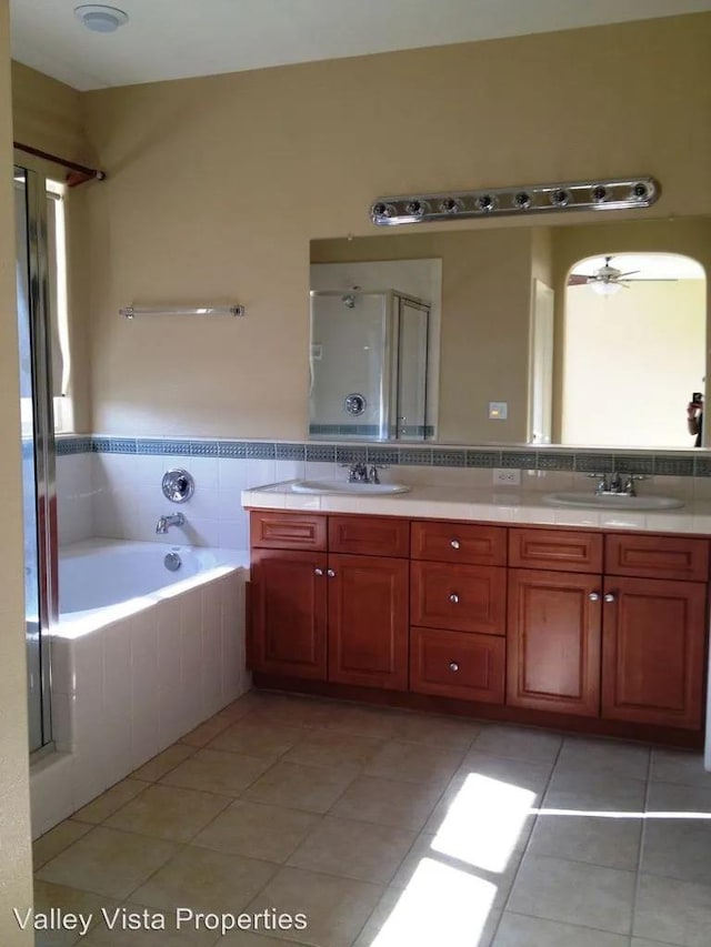 4077 W Peach Tree Ln, Fresno, CA 93722 - bathroom featuring double vanity, tile patterned floors, a sink, and a stall shower