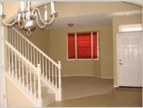 4077 W Peach Tree Ln, Fresno, CA 93722 - foyer entrance featuring baseboards, an inviting chandelier, and stairway