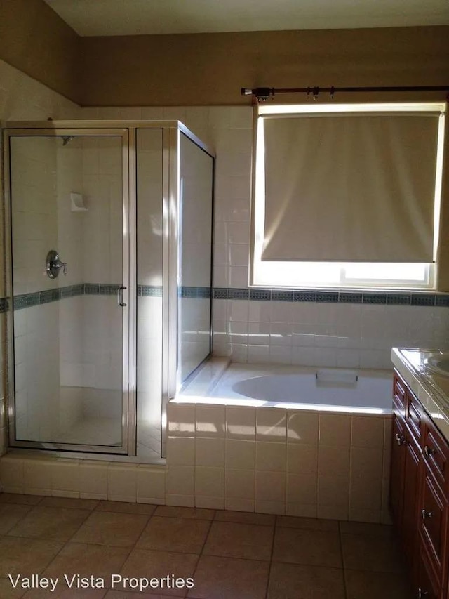 4077 W Peach Tree Ln, Fresno, CA 93722 - bathroom with tile patterned flooring, vanity, a bath, and a shower stall