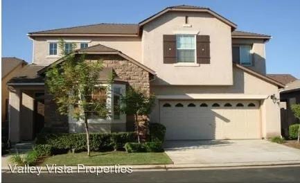4077 W Peach Tree Ln, Fresno, CA 93722 - traditional-style home with a garage, stucco siding, and concrete driveway