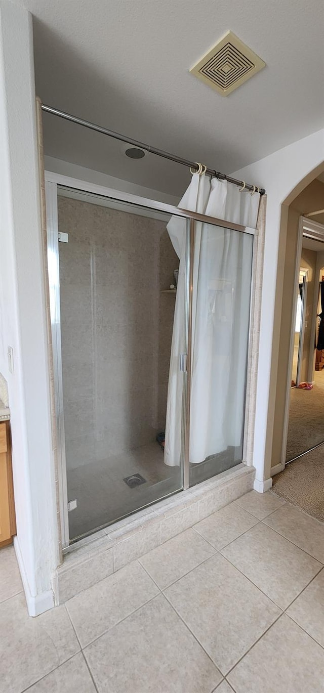 bathroom with visible vents, tile patterned flooring, and a stall shower