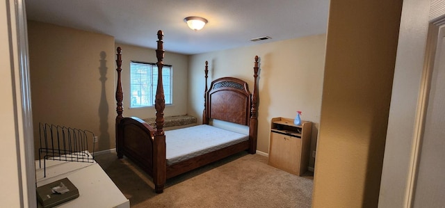 bedroom featuring visible vents, baseboards, and light carpet