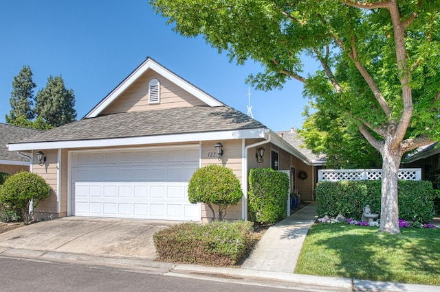 view of front of property with a shingled roof, an attached garage, and concrete driveway
