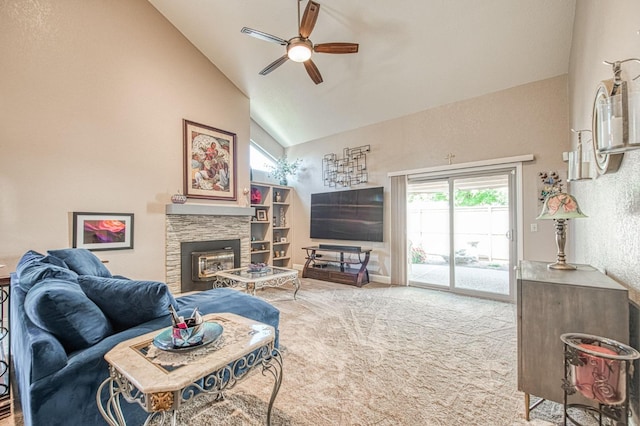 living area featuring a stone fireplace, carpet, ceiling fan, and high vaulted ceiling