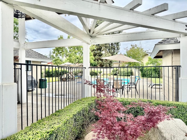 view of patio featuring fence, a fenced in pool, and a pergola