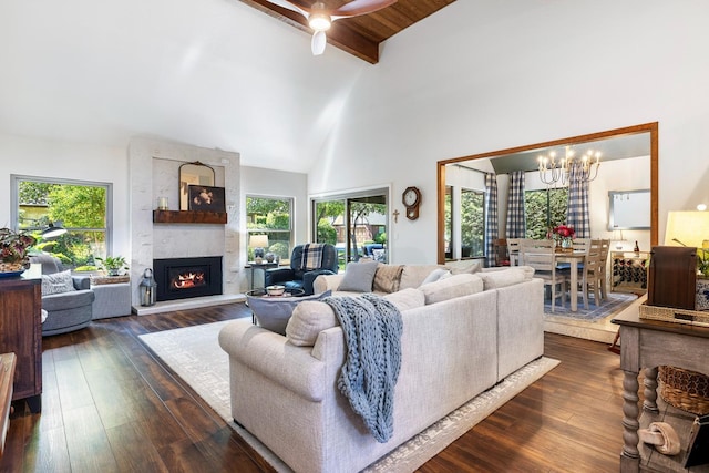 2827 W Compton Ct, Fresno, CA 93711 - living room featuring dark wood-style flooring, high vaulted ceiling, a large fireplace, and beam ceiling